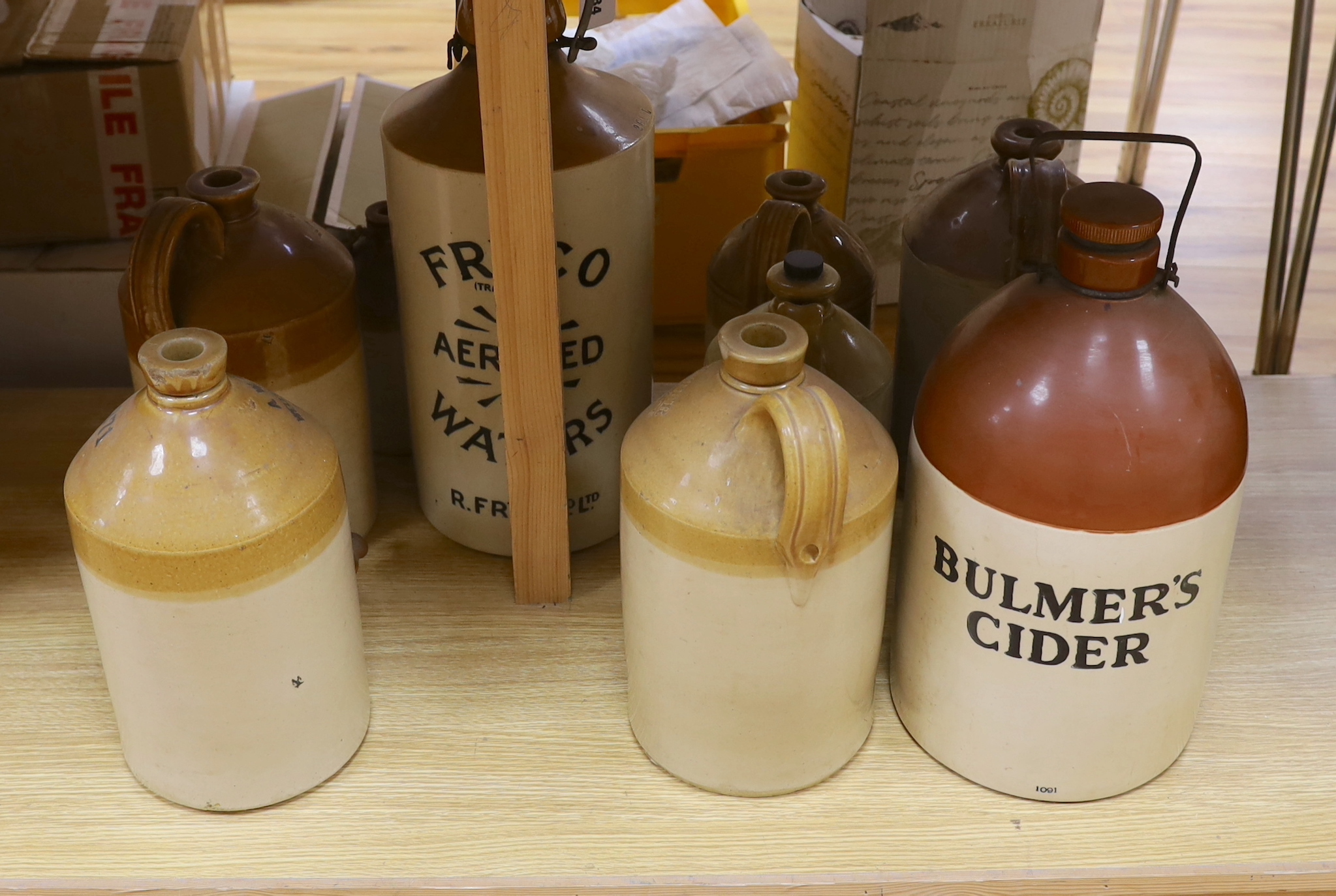 9 various stoneware vessels including local brewers such as Lewes, Worthing, Hastings and Brighton